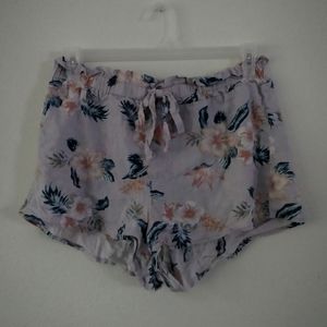 Pale blue high-waisted tropical print shorts